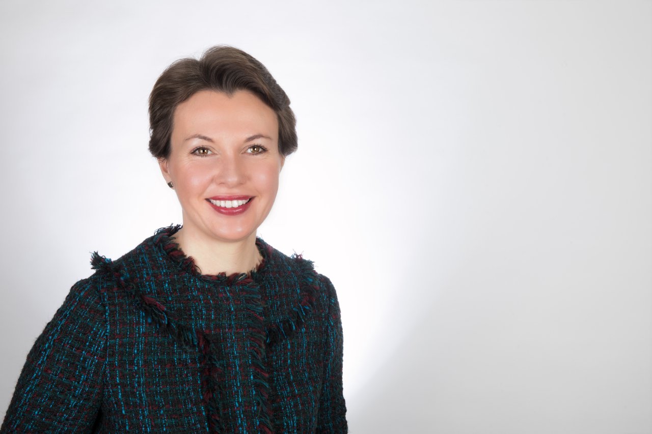 Joanna Gaudoin Smiling on a plain background.
